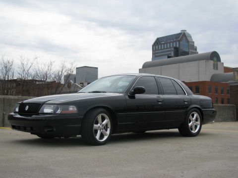 2003 Mercury Marauder - Black 2003 Mercury Marauder parked on a cloudy day with urban buildings behind it.