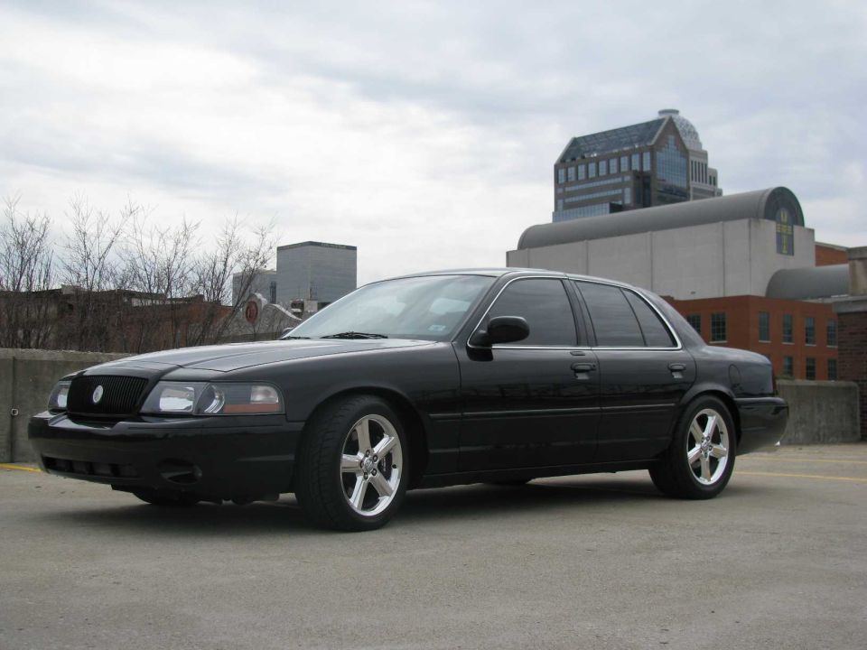 Black 2003 Mercury Marauder parked on concrete with buildings in background