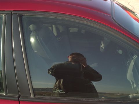 2000 Ford Taurus - A reflection in the window shows the car's interior and the photographer.