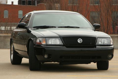 2003 Mercury Marauder - A black 2003 Mercury Marauder is parked outdoors with a brick building behind it.