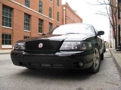 2003 Mercury Marauder - Black 2003 Mercury Marauder parked curbside in front of a brick building.