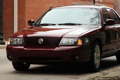 2003 Mercury Marauder - A dark red sedan with a prominent vertical grille is parked on a street.