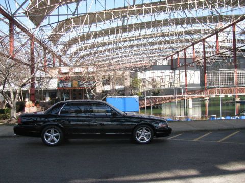 2003 Mercury Marauder - Side view of a black 2003 Mercury Marauder parked outdoors.