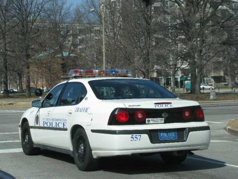 2003 Mercury Marauder - A white police sedan is seen from the rear, with "POLICE" and "557" visible on the trunk.