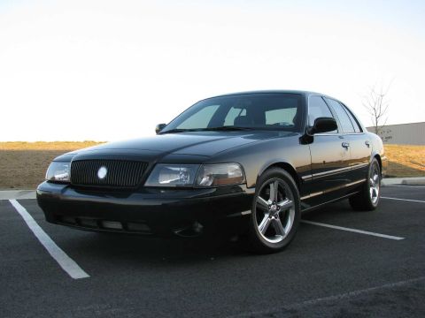 2003 Mercury Marauder - Front 3/4 view of a black 2003 Mercury Marauder parked in a lot with a white line on the asphalt.