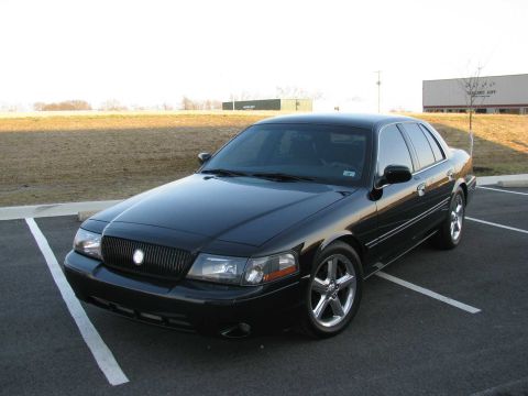 2003 Mercury Marauder - This black 2003 Mercury Marauder is parked in a lot with a building in the background.