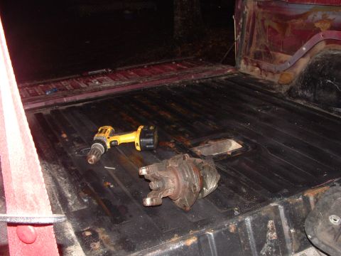 1979 Ford Bronco - Tools and a driveshaft component are visible inside the cargo area of a vehicle.