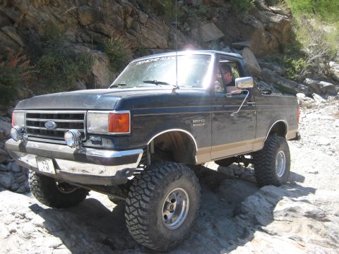 1991 Ford Bronco - This 1991 Ford Bronco is shown off-road, equipped with large tires for tackling rough terrain.
