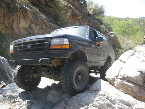 1991 Ford Bronco - Ford Bronco tackling a challenging rocky terrain, its off-road capabilities.