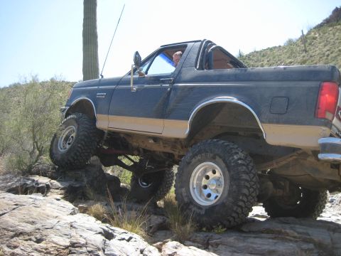 1991 Ford Bronco - This 1991 Ford Bronco is navigating a rocky off-road course in a desert environment.