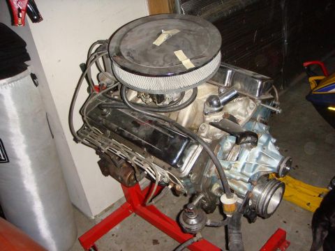 1975 Chevrolet Corvette - Engine assembly on a red stand, an air cleaner and carburetor, likely awaiting installation or rebuild.