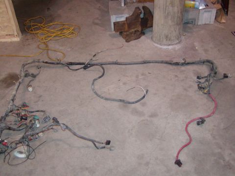 1991 Ford Bronco - A complex vehicle wiring harness is spread out on the floor, showing numerous connectors and wires.