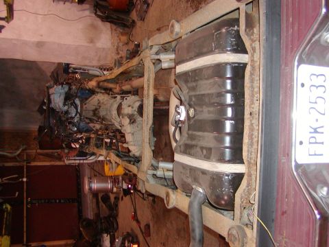 1991 Ford Bronco - Frame and drivetrain components of a Ford Bronco, likely undergoing disassembly.