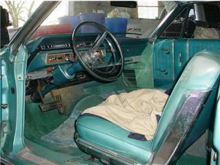 1972 Ford Ranchero - The interior of a classic car features teal upholstery and a dashboard with various controls.