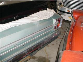 1972 Ford Ranchero - The rear of a light blue 1972 Ford Ranchero is partially covered and parked indoors with other vehicles.