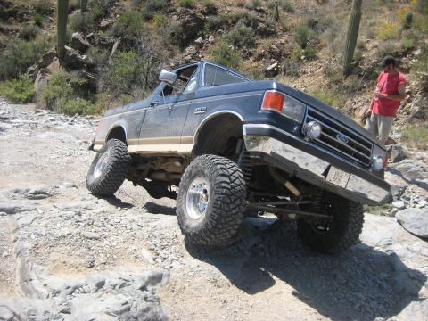 1991 Ford Bronco - This lifted 1991 Ford Bronco tackles a challenging rocky terrain, its off-road capabilities.