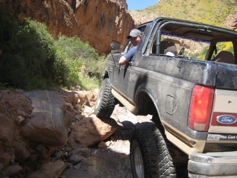 1991 Ford Bronco - This 1991 Ford Bronco is tackling a challenging rocky trail in a desert canyon.