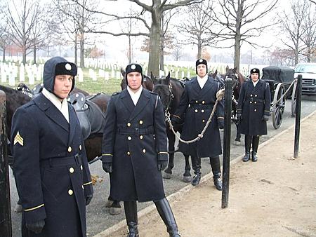 1982 Toyota 4Runner - Four soldiers in ceremonial uniforms stand with horses and a horse-drawn carriage in a cemetery setting.