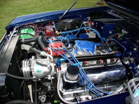 1978 Ford F-250 - Close-up of a vehicle's engine bay, showing various components and blue wiring.