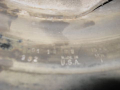 1964 Chevrolet Corvette - A close-up view of a stamped part reveals manufacturing details and origin.
