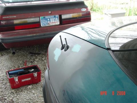 1993 Ford Probe - A teal 1993 Ford Probe is parked next to a red Ford Mustang.