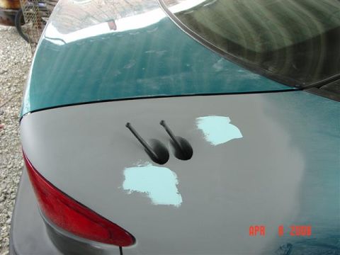 1993 Ford Probe - Rear view of a 1993 Ford Probe undergoing bodywork, showing primer and antenna bases.