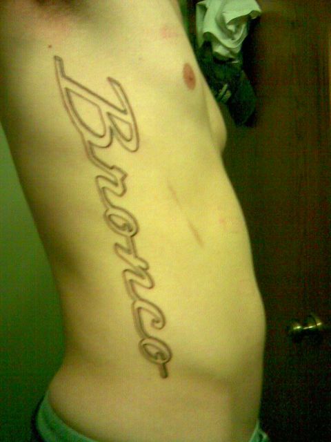 1994 Ford Bronco - A tattoo of the word Bronco is visible on a person's side.