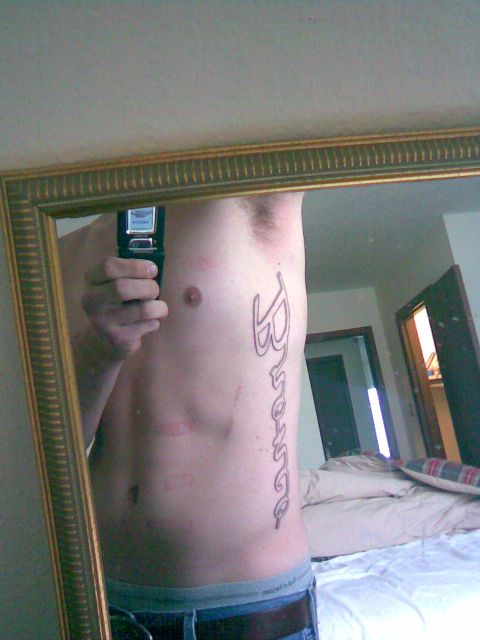 1994 Ford Bronco - A tattoo of the word 'Bronco' is visible on a person's side, reflected in a mirror.