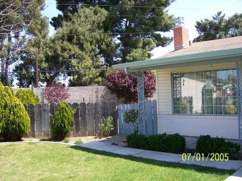 1991 Ford Bronco - A suburban house exterior is shown with a well-maintained yard and a date stamp from 2005.