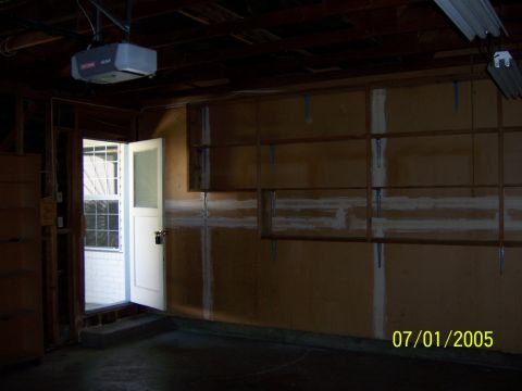 1991 Ford Bronco - Interior view of a garage with unfinished walls and shelving.