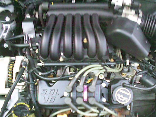 Black 3.0L V6 engine bay with intake manifold and spark plug wires
