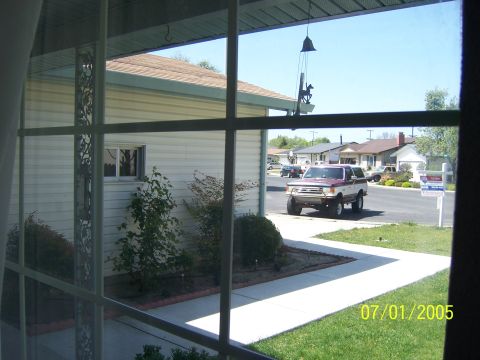 1991 Ford Bronco - A two-tone 1991 Ford Bronco is parked in the driveway of a suburban home.