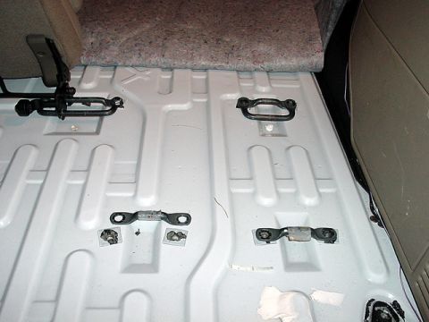 1983 Ford Bronco - Close-up of the cargo area floor showing tie-down points and seat hardware.