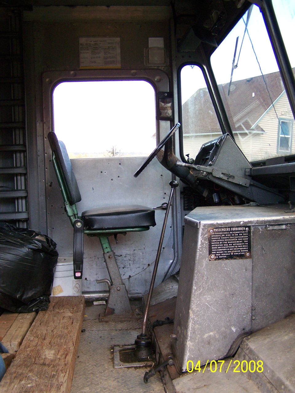 Interior of a step van delivery truck cab with driver seat