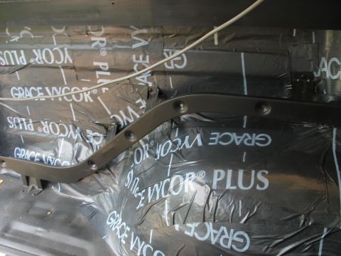 1978 Ford Bronco - Interior view of a vehicle showing soundproofing material and a metal trim piece.