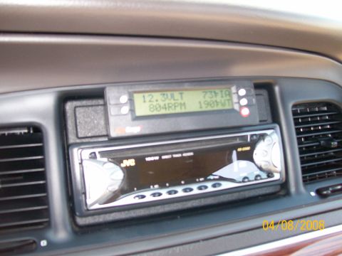 1995 Mercury Grand Marquis - Aftermarket stereo and digital gauge cluster installed in a vehicle's dashboard.
