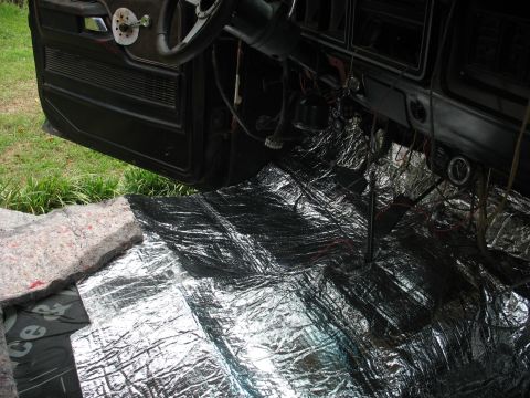 1978 Ford Bronco - Soundproofing installation in progress inside a vehicle's cabin.