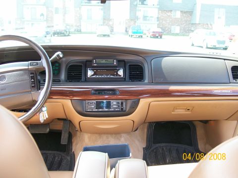 1995 Mercury Grand Marquis - Passenger-side view of a Mercury Grand Marquis dashboard with woodgrain trim, tan leather and an aftermarket head unit; date stamp 04/08/20…