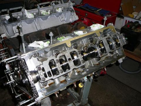 1997 Mercury Grand Marquis - Close-up of an engine block undergoing repair, showing internal components and a timing chain mechanism.