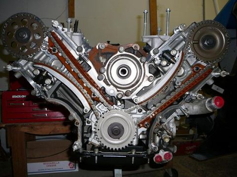 1997 Mercury Grand Marquis - Close-up view of an engine's timing chain and gear system, likely a V-configuration engine.