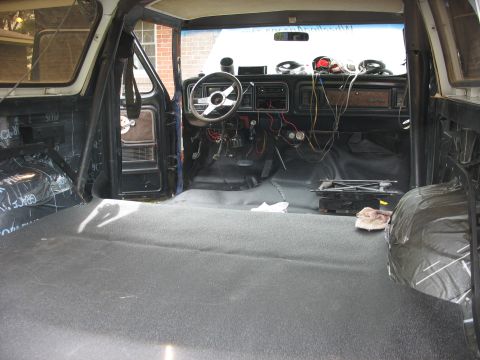 1978 Ford Bronco - The interior of a 1978 Ford Bronco shows exposed wiring and a removed passenger seat, indicating ongoing work.