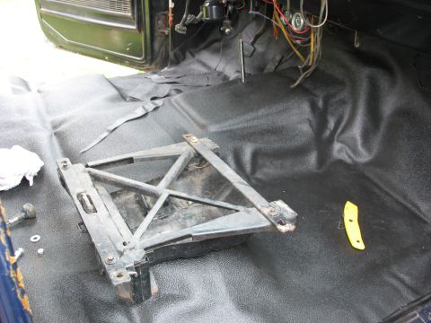 1978 Ford Bronco - Vehicle interior floor shows removed seat bracket and exposed wiring, indicating ongoing work.