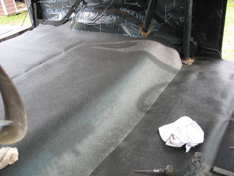 1978 Ford Bronco - The interior floor of a vehicle shows new carpeting and sound deadening material being installed.