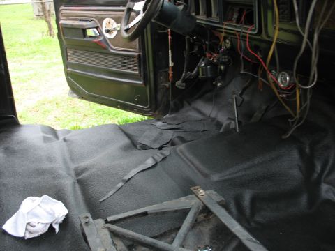 1978 Ford Bronco - The interior of a 1978 Ford Bronco shows new black carpeting and a partially disassembled dashboard with visible wiring.