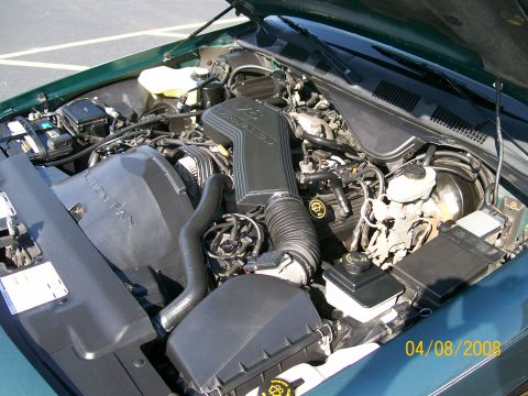 1995 Mercury Grand Marquis - Engine bay of a 1995 Mercury Grand Marquis, showing the V8 engine and associated components.