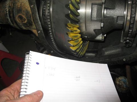 1990 Ford F-250 - Close-up of differential gears with a handwritten notebook detailing measurements.