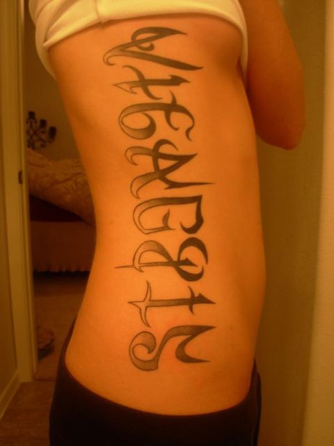 1991 Ford Bronco - A tattoo with script lettering is visible on the side of a person's torso.