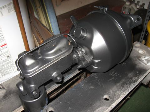 1968 Shelby GT500 - Newly painted brake booster and master cylinder assembly sits on a workbench.