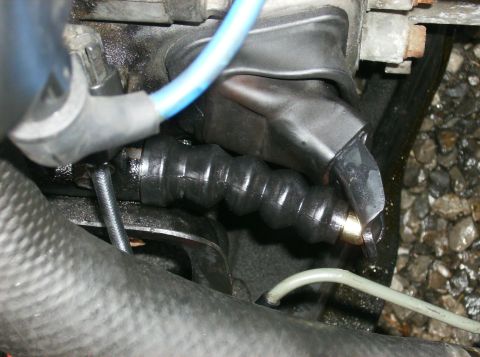 1995 Ford Probe - Close-up view of a clutch slave cylinder boot and linkage, with visible text from SuperMotors.net.