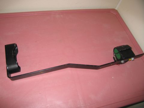 1991 Ford LTD Crown Victoria - This is a black metal bracket with a housing containing green cylinders and yellow wires.